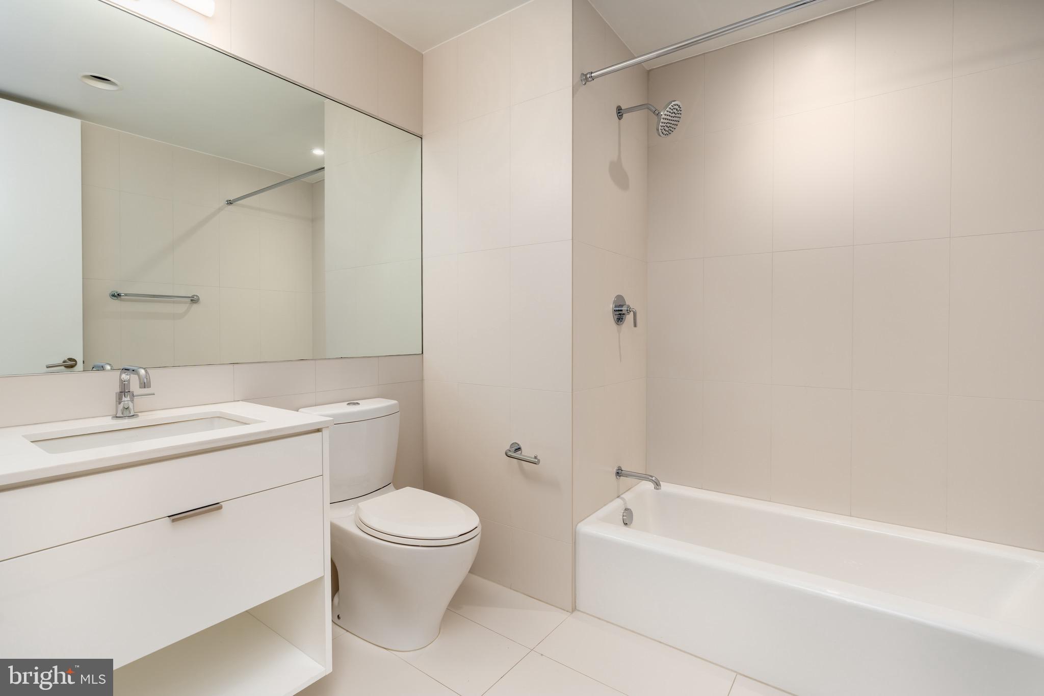 1110 23rd Street Northwest, Unit 505 Washington, DC 20037 - Photo 9 of 25 a bathroom with a toilet a sink and a bathtub