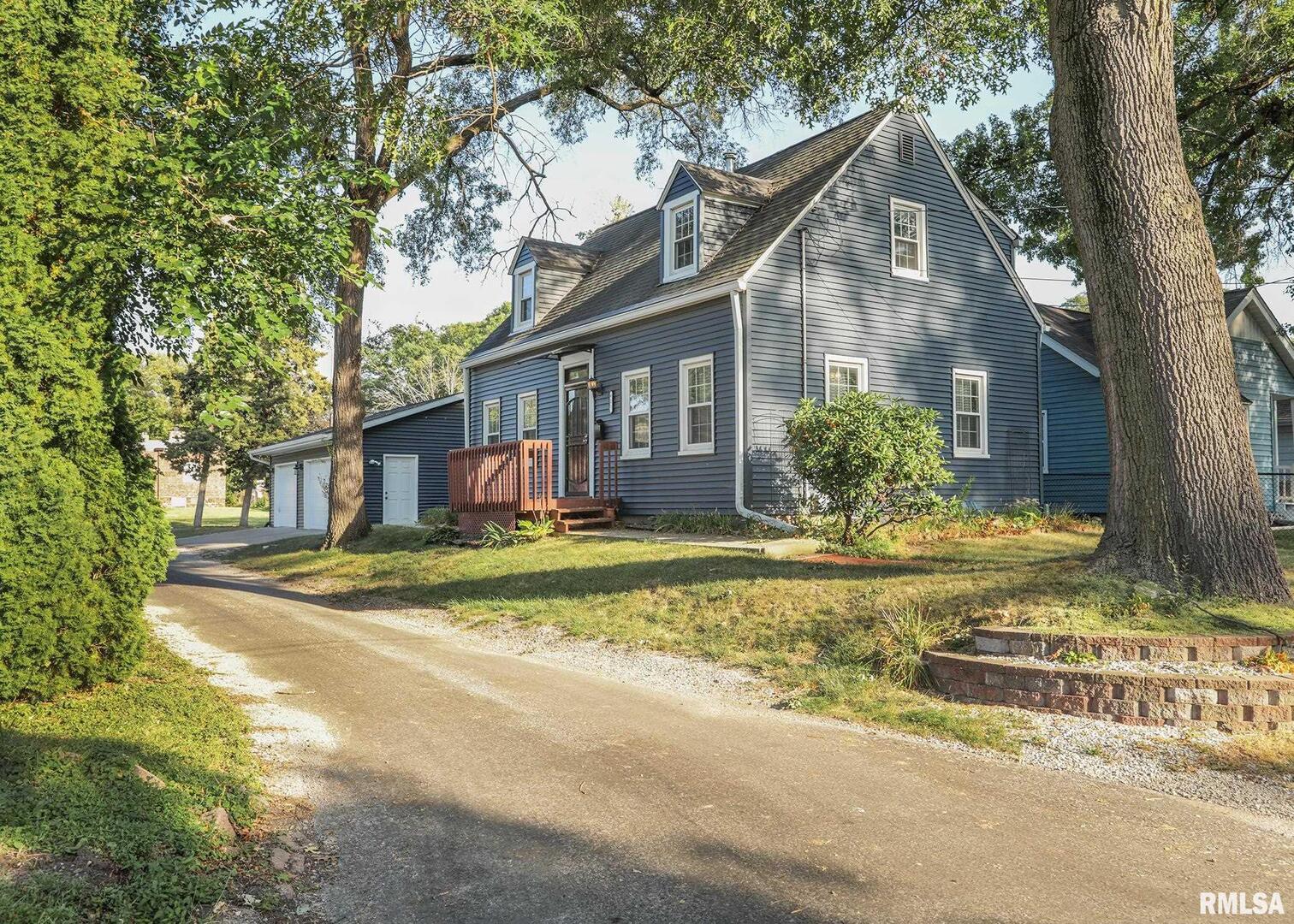 a front view of a house with a yard table and chairs