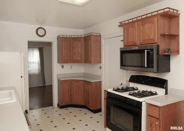 a kitchen with stainless steel appliances a stove a refrigerator and cabinets