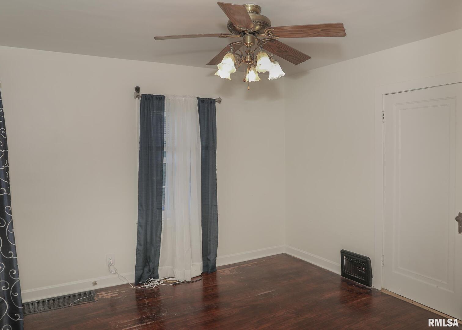 421 10th Street, Unit A Silvis, IL 61282 - Photo 18 of 37 an empty room with wooden floor fan and windows