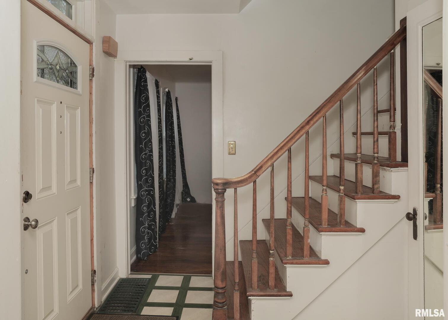 421 10th Street, Unit A Silvis, IL 61282 - Photo 19 of 37 a view of staircase with lots of frames on wall and door