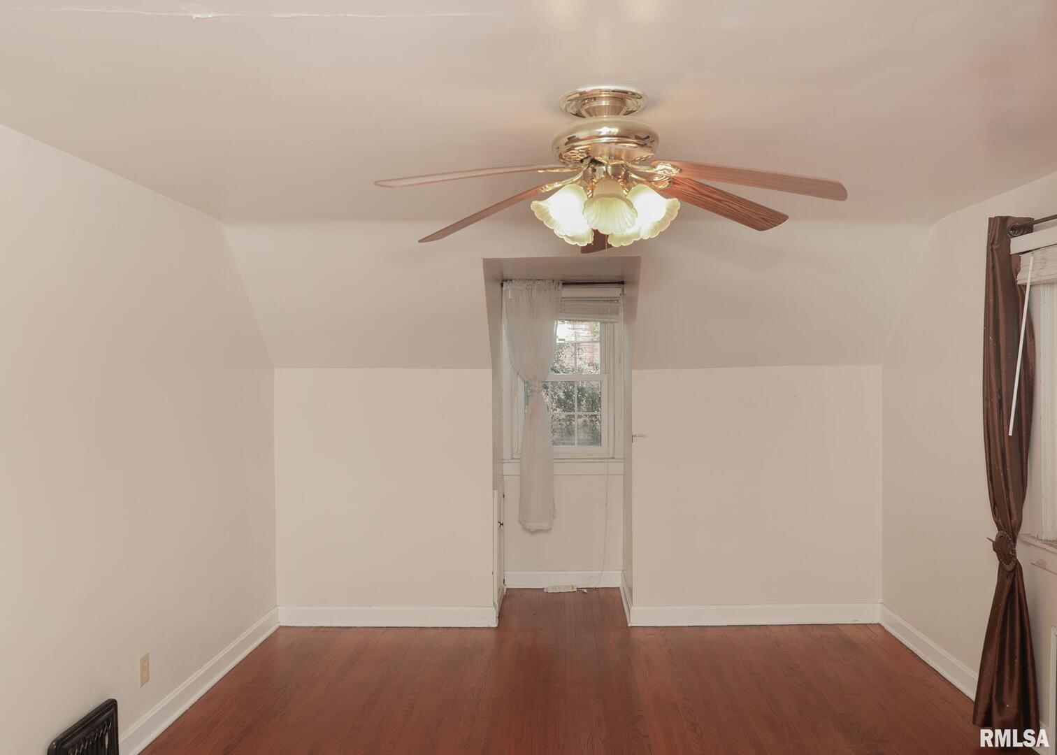 421 10th Street, Unit A Silvis, IL 61282 - Photo 23 of 37 an empty room with wooden floor and chandelier fan