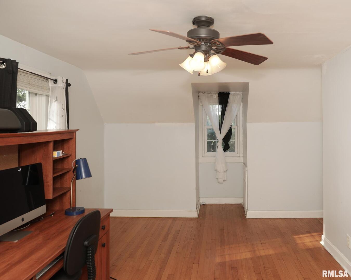 421 10th Street, Unit A Silvis, IL 61282 - Photo 27 of 37 a view of a livingroom with wooden floor and a ceiling fan