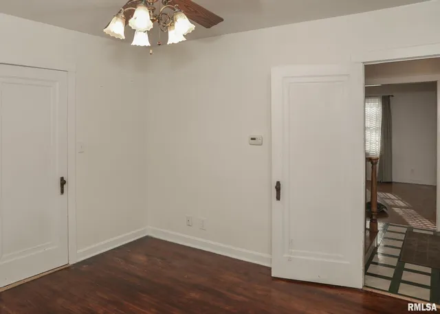 an empty room with wooden floor and closet