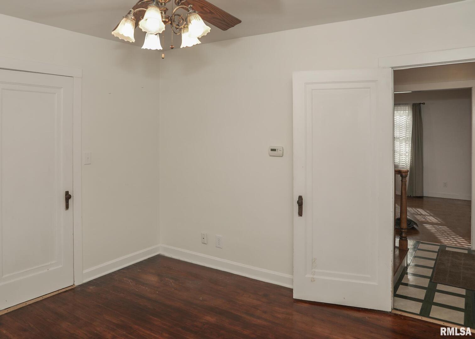 421 10th Street, Unit A Silvis, IL 61282 - Photo 29 of 37 an empty room with wooden floor and closet