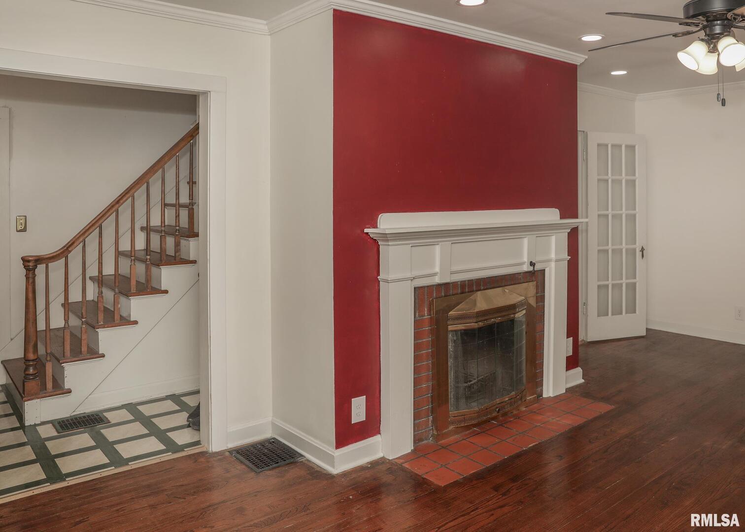 421 10th Street, Unit A Silvis, IL 61282 - Photo 5 of 37 a view of an empty room with wooden floor and a fireplace