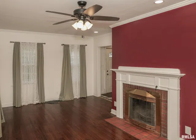 a view of a livingroom with a fireplace and wooden floor