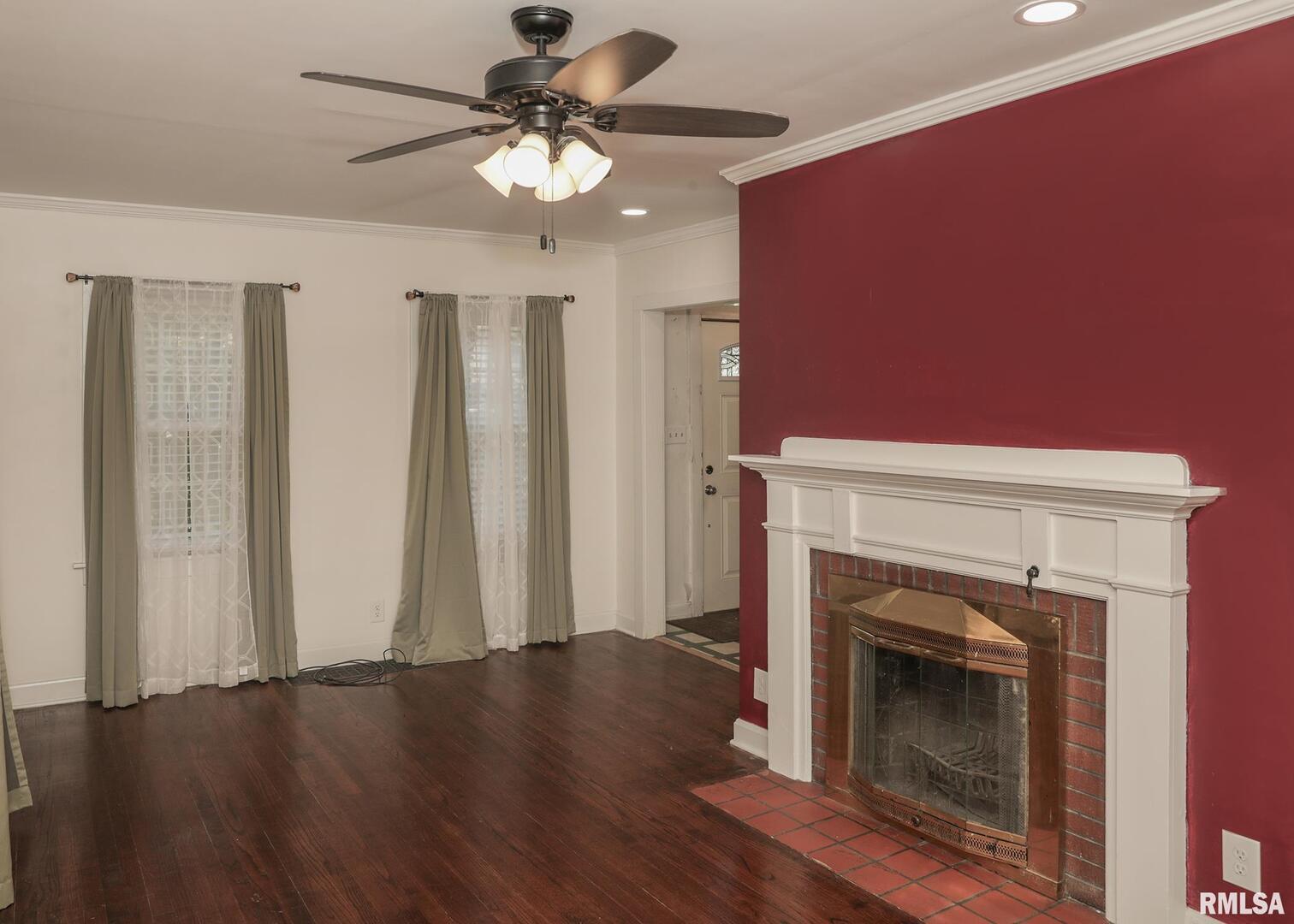 421 10th Street, Unit A Silvis, IL 61282 - Photo 7 of 37 a view of a livingroom with a fireplace and wooden floor