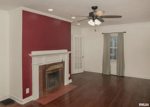a view of an empty room with a fireplace