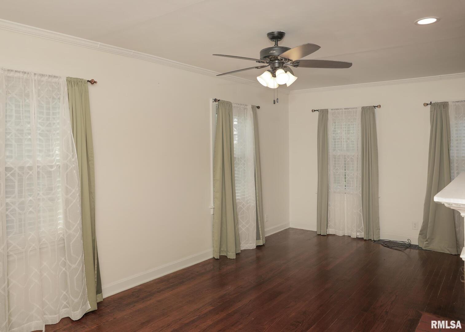 421 10th Street, Unit A Silvis, IL 61282 - Photo 10 of 37 a view of a livingroom with wooden floor and a ceiling fan