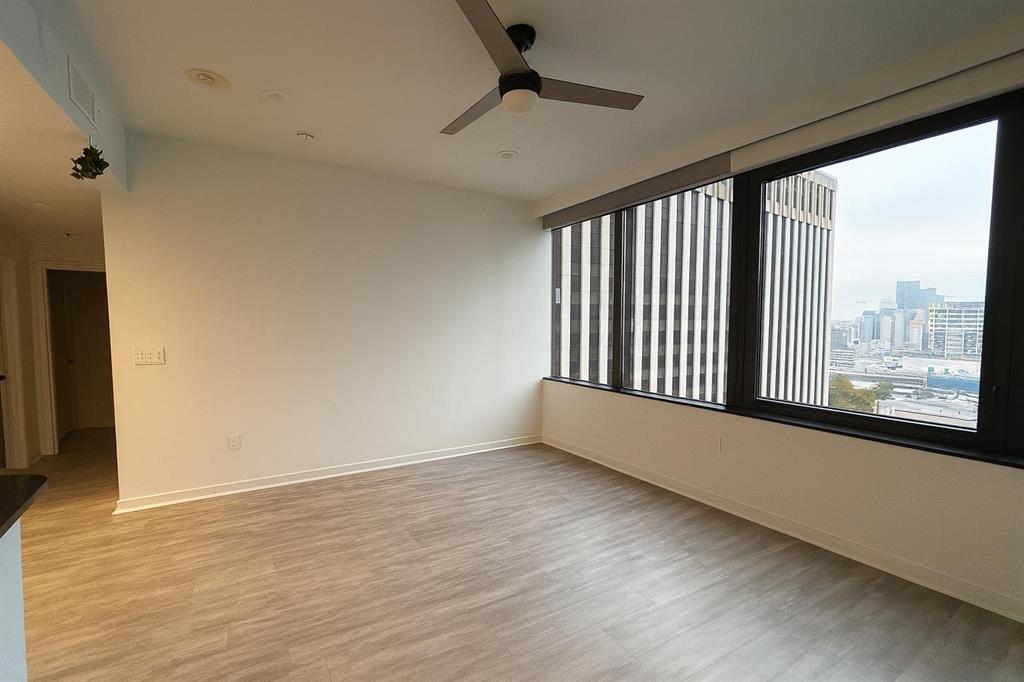 1200 Main Street, Unit 902 Dallas, TX 75202 - Photo 11 of 13 a view of an empty room with wooden floor and a window