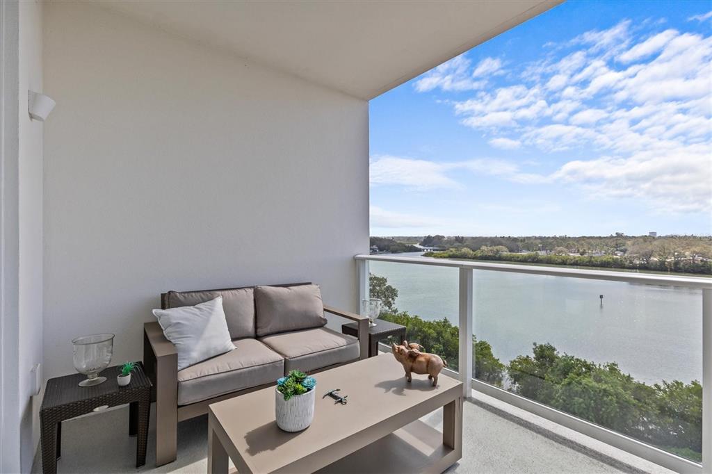 1020 Sunset Point Road, Unit 510 Clearwater, FL 33755 - Photo 24 of 44 a terrace with outdoor seating and trees