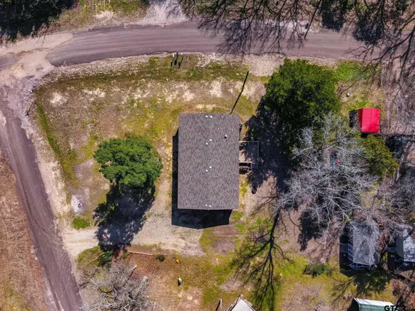 an aerial view of a houses with a yard