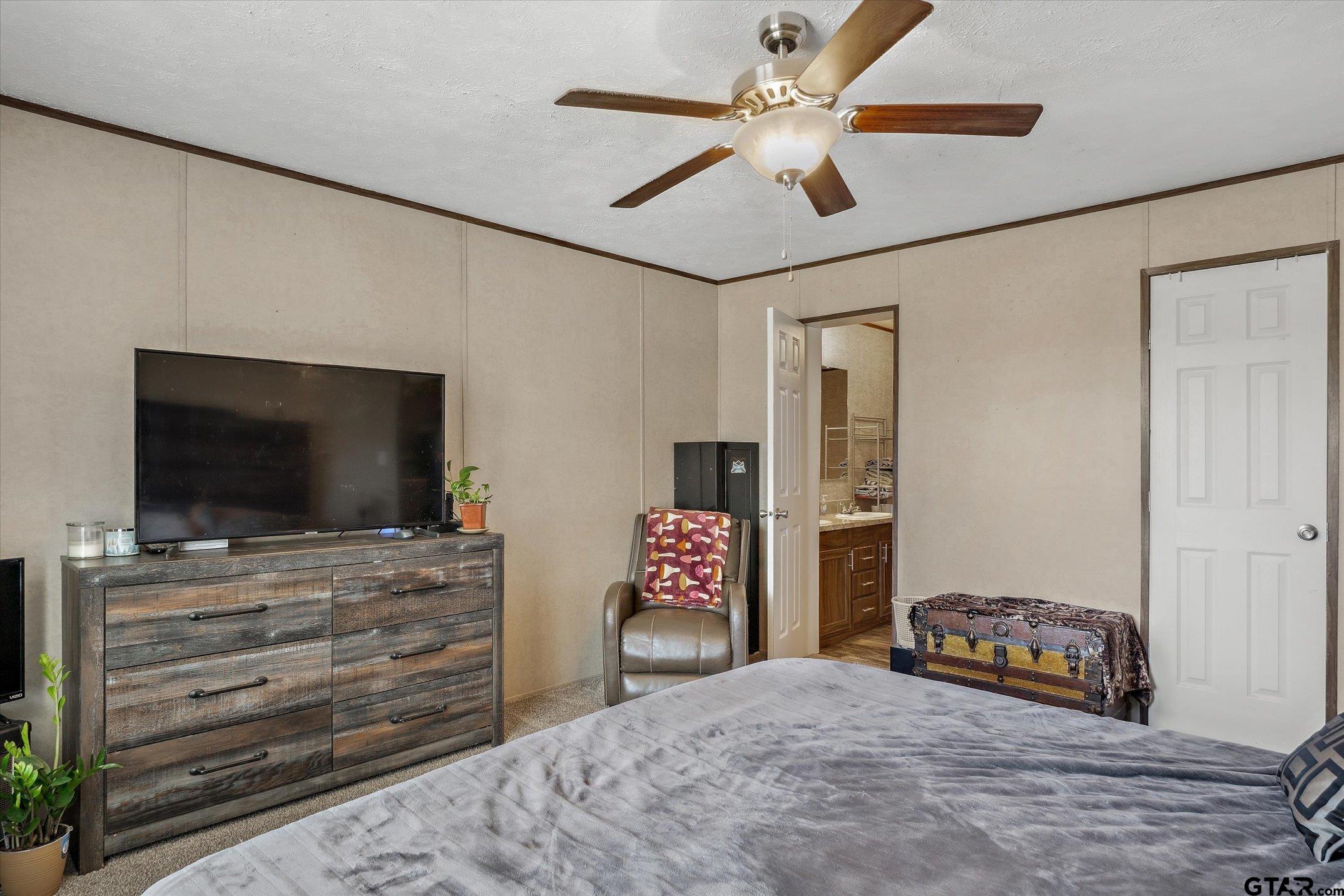 129 Elm Drive Murchison, TX 75778 - Photo 13 of 34 a bedroom with furniture and a flat screen tv