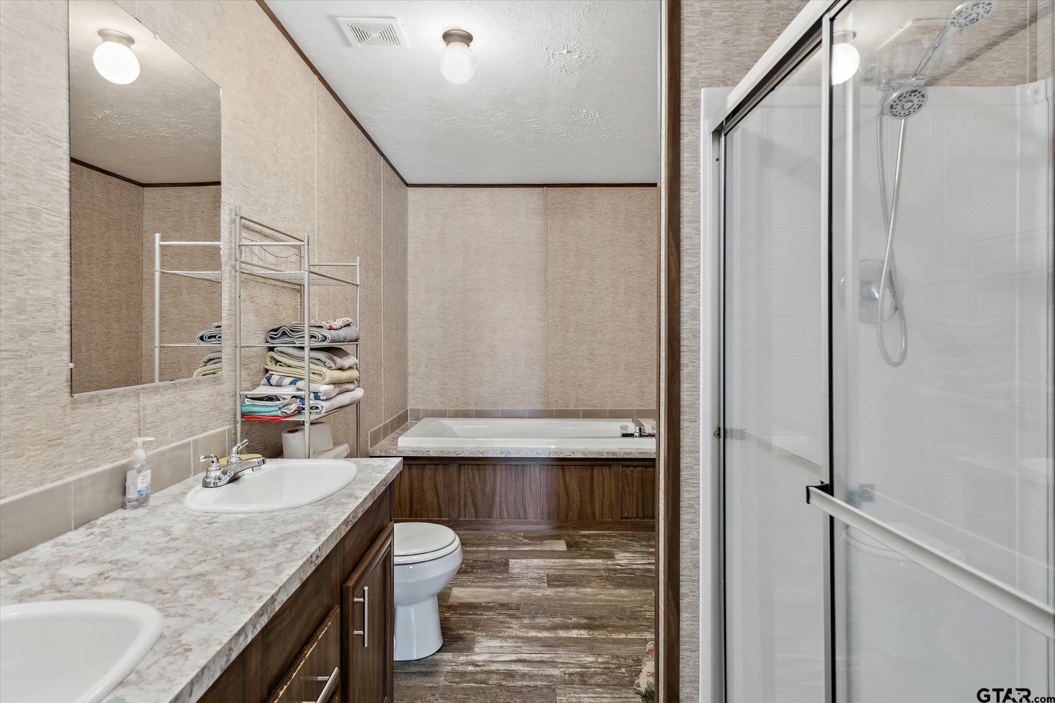 129 Elm Drive Murchison, TX 75778 - Photo 14 of 34 a bathroom with a granite countertop sink a mirror and shower