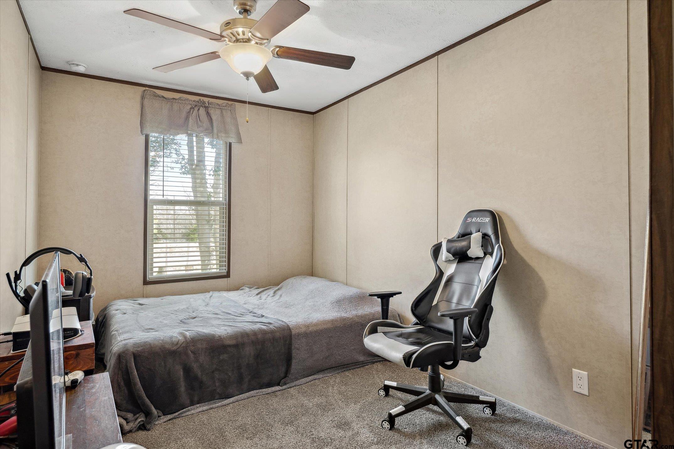 129 Elm Drive Murchison, TX 75778 - Photo 18 of 34 a bedroom with a bed and a desk