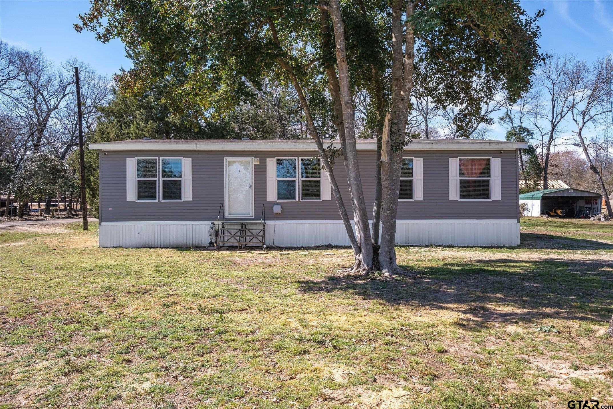 129 Elm Drive Murchison, TX 75778 - Photo 23 of 34 a house that has a tree in front of the house