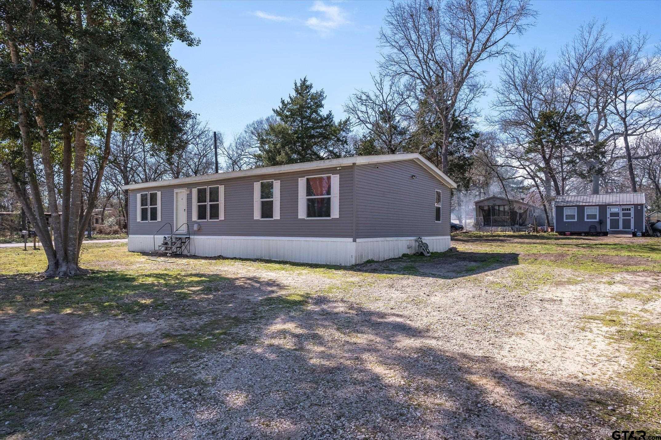 129 Elm Drive Murchison, TX 75778 - Photo 24 of 34 a view of a house with a yard