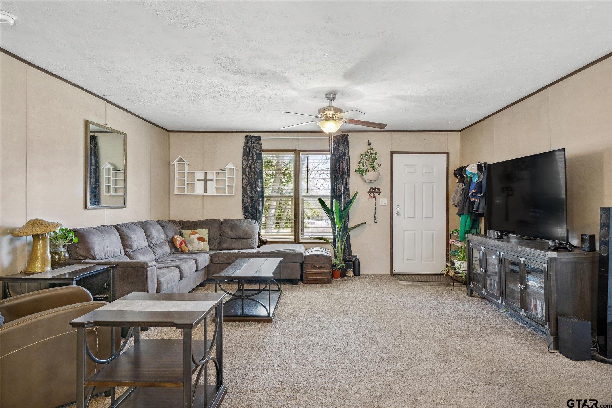 129 Elm Drive Murchison, TX 75778 - Photo 6 of 34 a living room with furniture and a flat screen tv