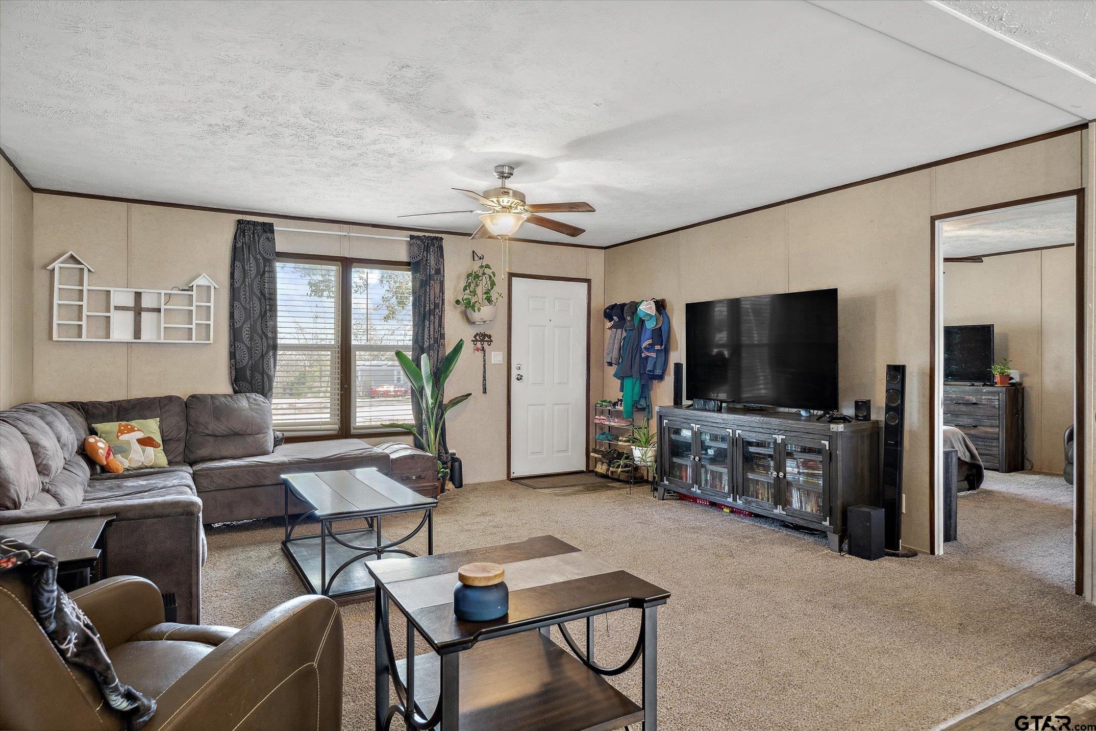 129 Elm Drive Murchison, TX 75778 - Photo 8 of 34 a living room with furniture and a flat screen tv