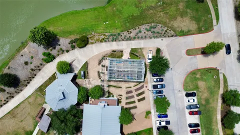 an aerial view of a swimming pool with outdoor seating