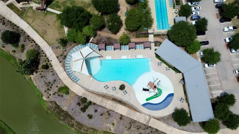 an aerial view of a house with a garden and lake view