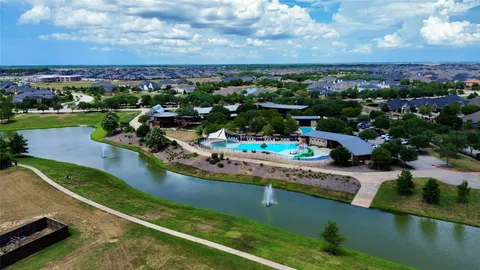a view of a water fountain and a floor to ceiling window