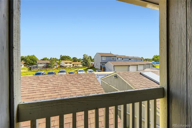 a view of a balcony with chair and wooden floor