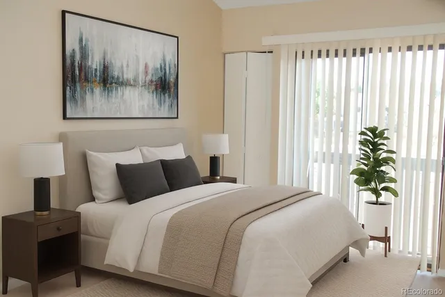 a bedroom with a bed and a painting on the wall