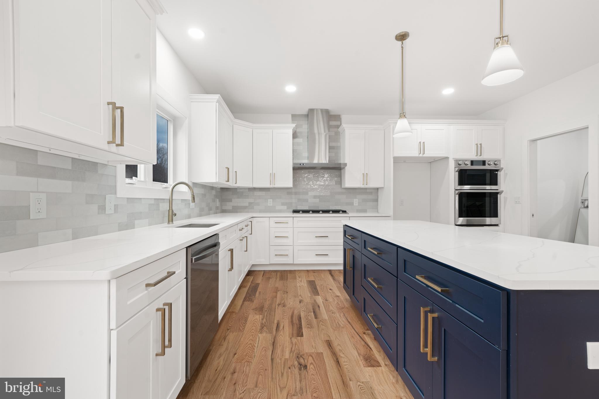 414 Flock Road Hamilton, NJ 08619 - Photo 25 of 60 a large kitchen with stainless steel appliances sink a microwave and cabinets