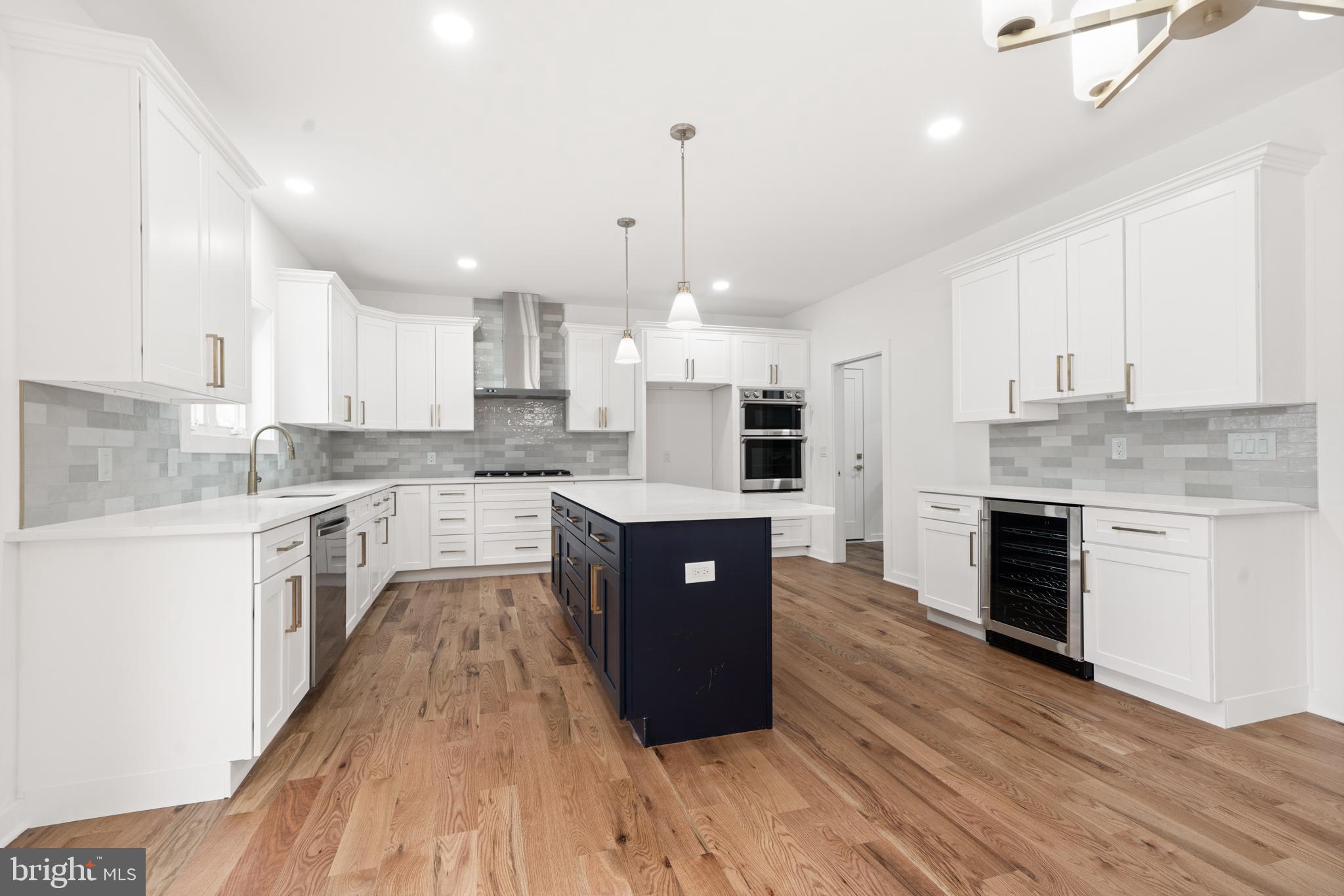 414 Flock Road Hamilton, NJ 08619 - Photo 27 of 60 a large kitchen with stainless steel appliances granite countertop a stove a sink dishwasher and a refrigerator with wooden floor