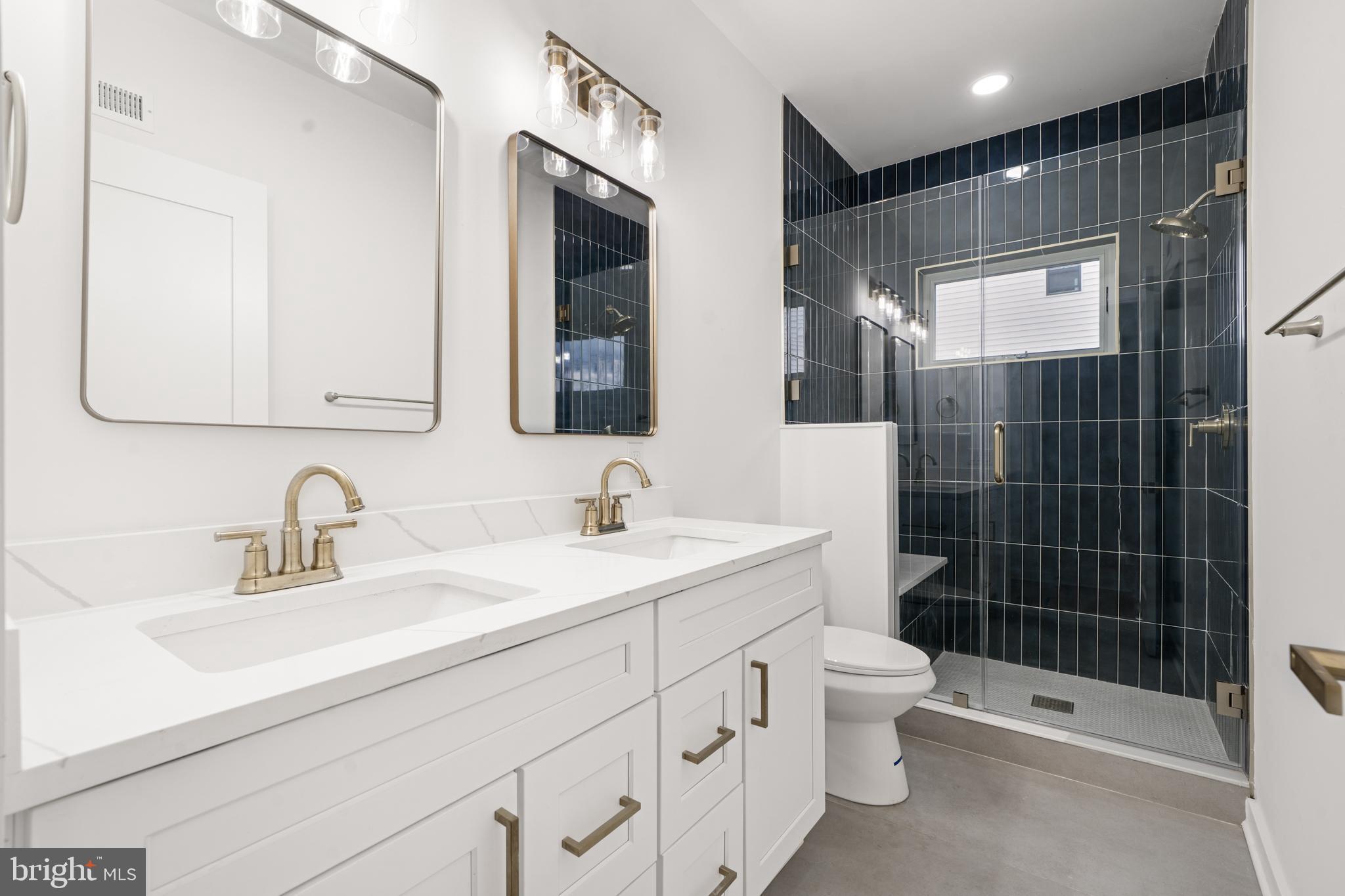 414 Flock Road Hamilton, NJ 08619 - Photo 39 of 60 a bathroom with a double vanity sink toilet and shower