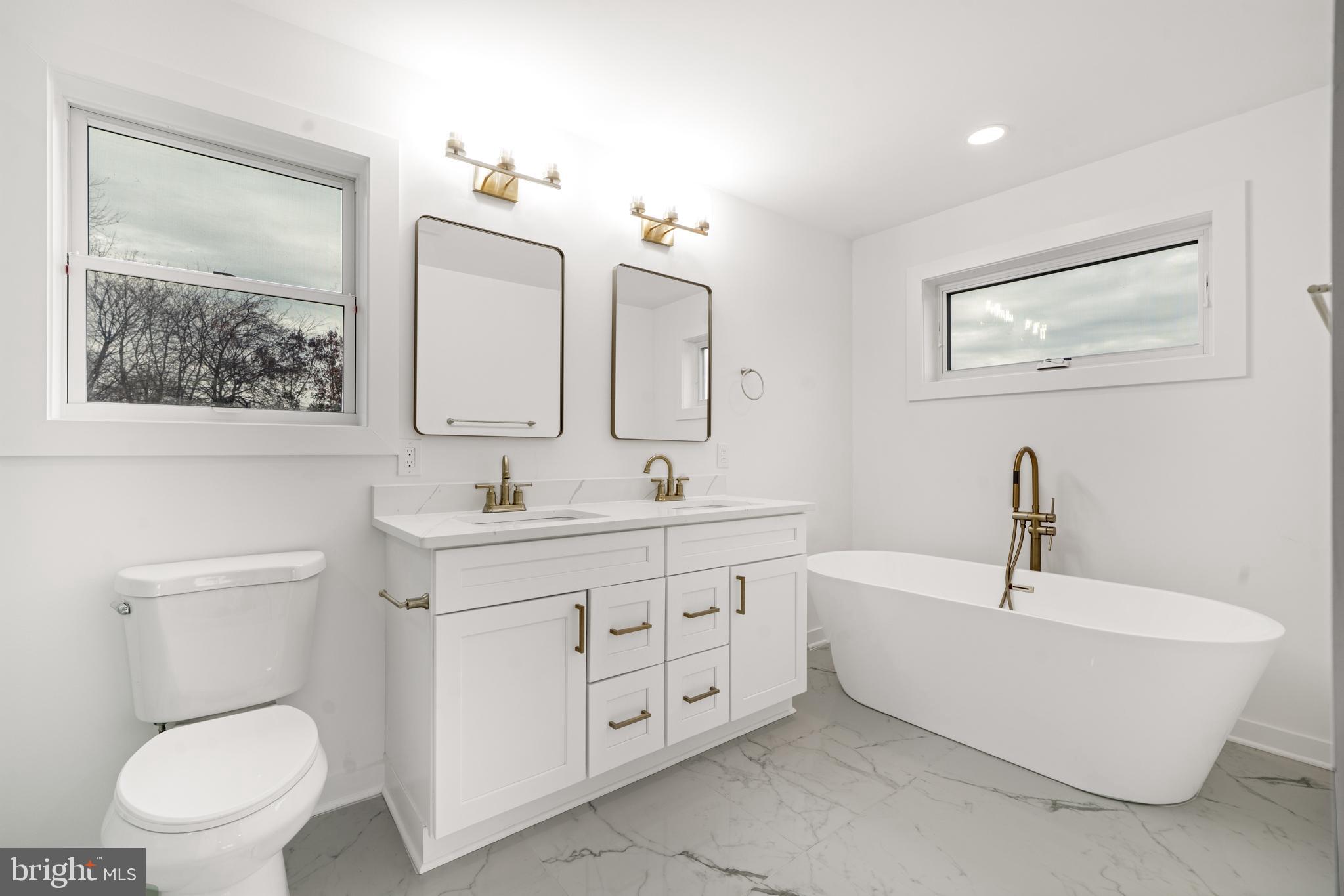 414 Flock Road Hamilton, NJ 08619 - Photo 40 of 60 a bathroom with a double vanity sink toilet and a mirror