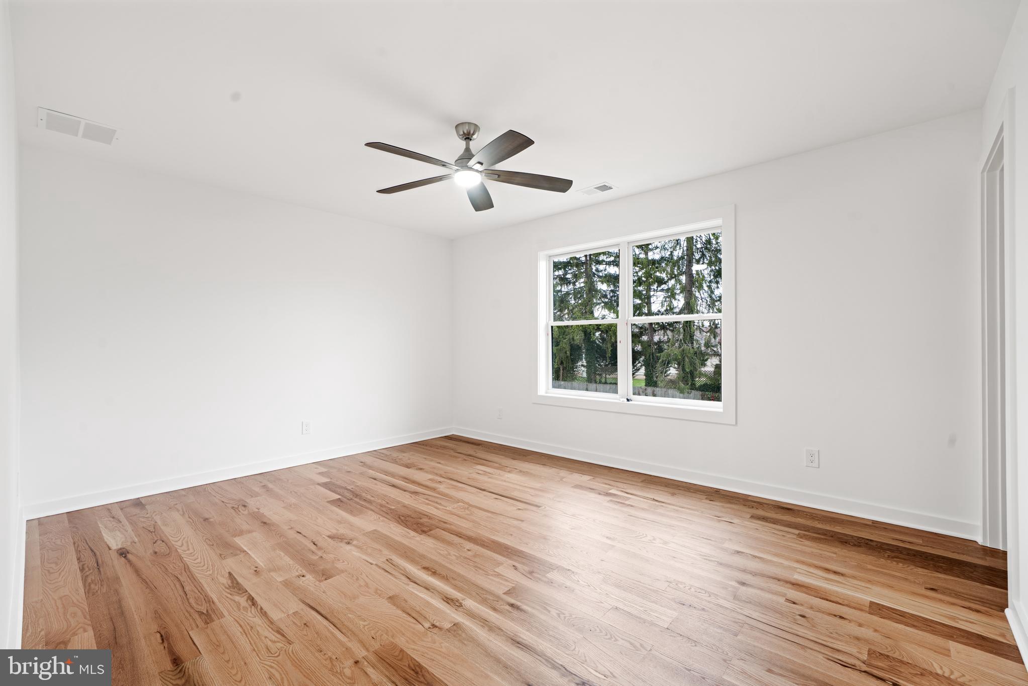 414 Flock Road Hamilton, NJ 08619 - Photo 47 of 60 a view of empty room with wooden floor and fan