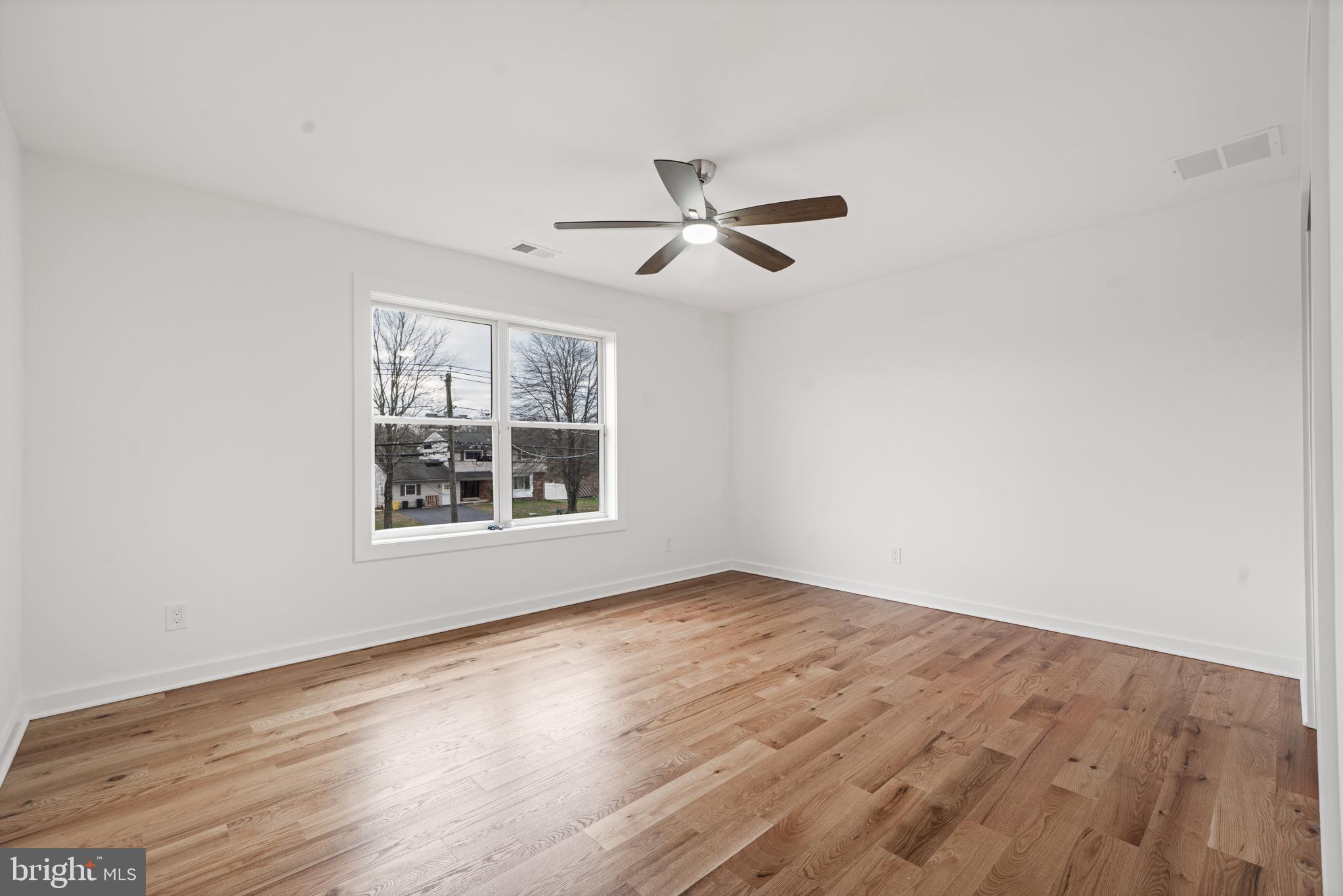 414 Flock Road Hamilton, NJ 08619 - Photo 48 of 60 a view of an empty room with wooden floor and a window