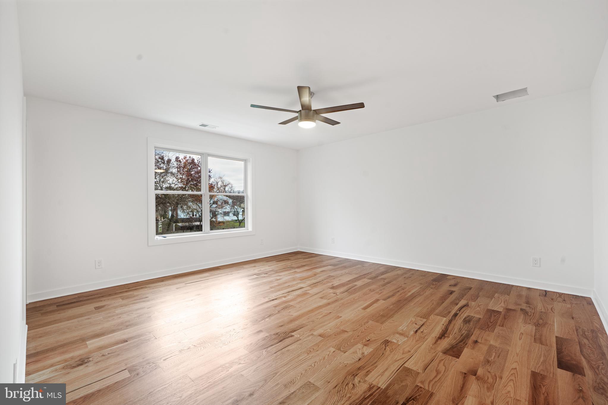 414 Flock Road Hamilton, NJ 08619 - Photo 49 of 60 an empty room with wooden floor and ceiling fan