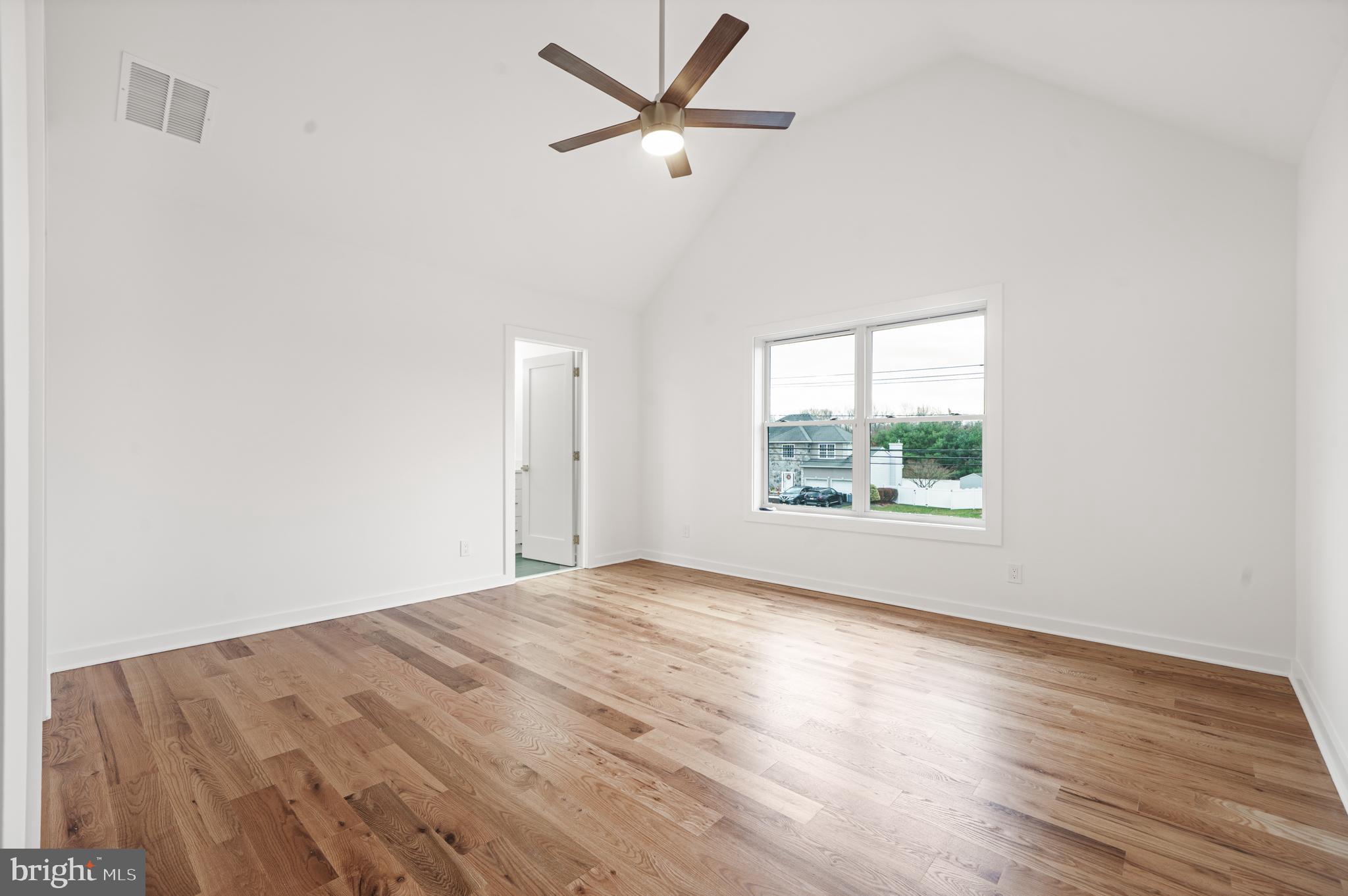 414 Flock Road Hamilton, NJ 08619 - Photo 50 of 60 an empty room with wooden floor ceiling fan and windows