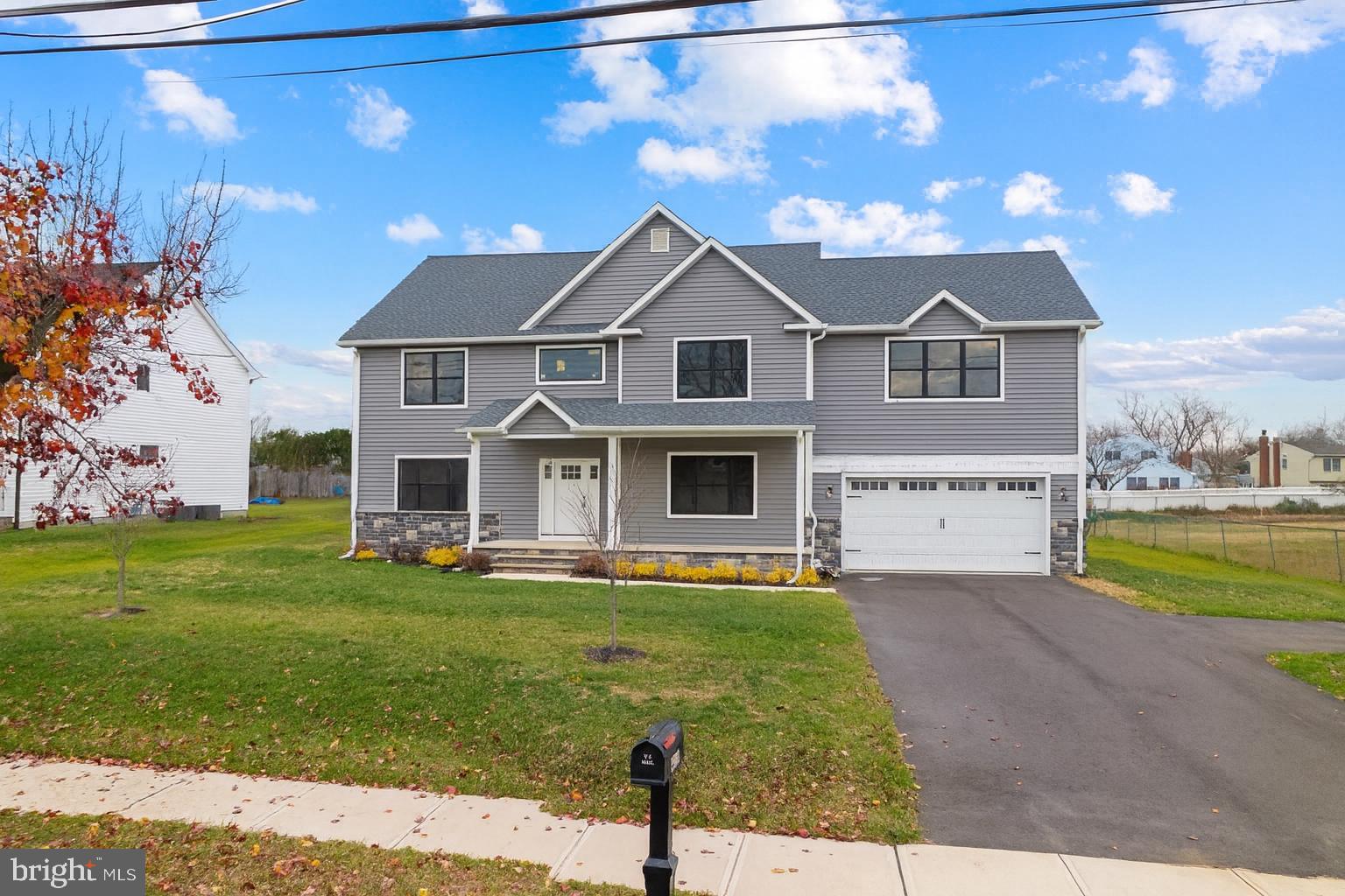 414 Flock Road Hamilton, NJ 08619 - Photo 6 of 60 a front view of a house with a yard and garage