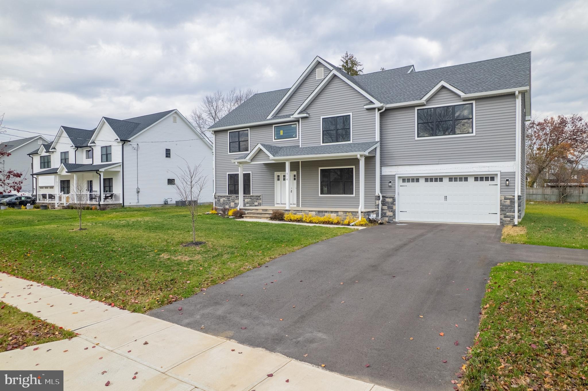 414 Flock Road Hamilton, NJ 08619 - Photo 9 of 60 a front view of a house with garage and yard