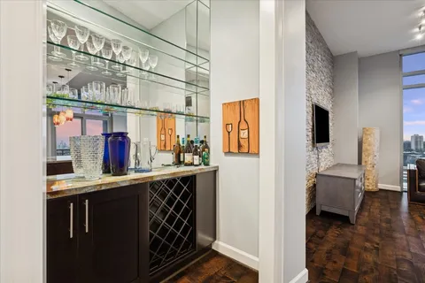 a bathroom with a granite countertop sink and a toilet