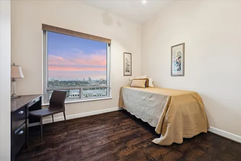 a bed sitting in a bedroom next to a window