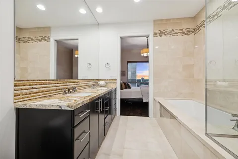 a en suite bathroom with a double vanity sink a mirror and a shower