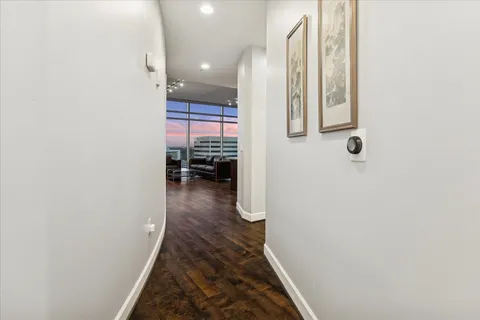 a large living room with stainless steel appliances kitchen island granite countertop a stove and a sink