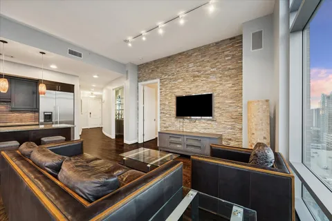 a living room with furniture and floor to ceiling window