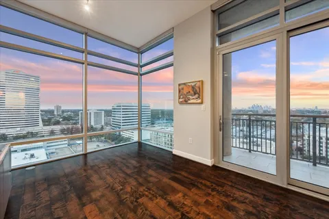 a living room with a large window and a flat screen tv