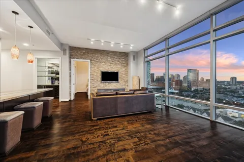 a kitchen with stainless steel appliances granite countertop a refrigerator a stove and a wooden floors