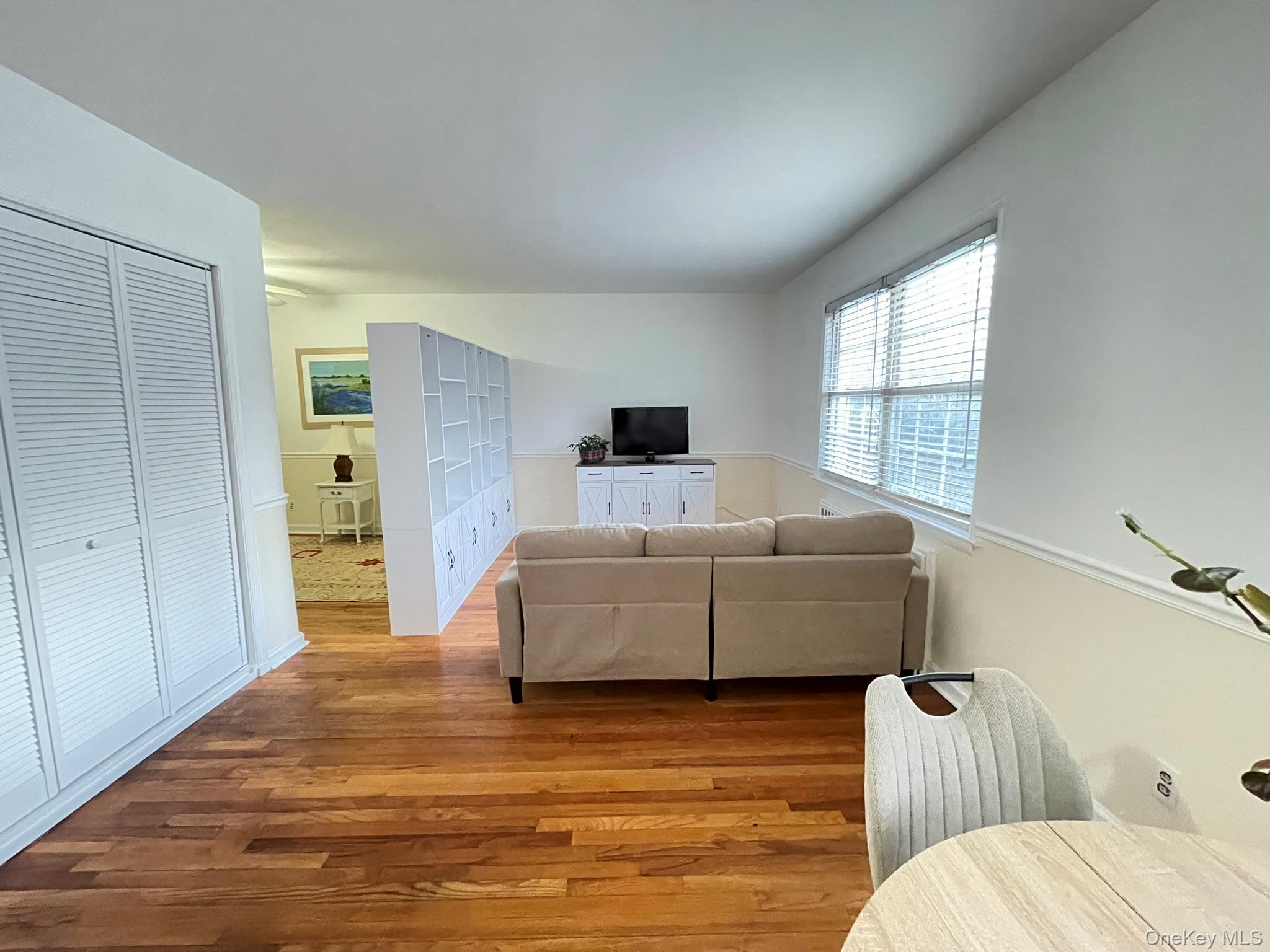180 Pinewood Road, Unit 11 Hartsdale, NY 10530 - Photo 5 of 13 a living room with furniture and wooden floor