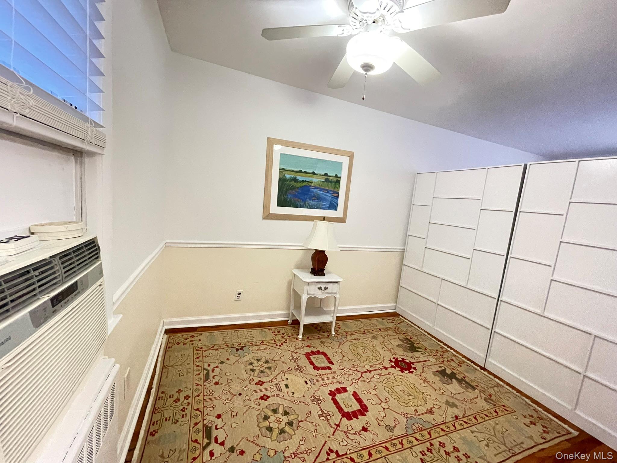 180 Pinewood Road, Unit 11 Hartsdale, NY 10530 - Photo 8 of 13 a living room with a baby crib furniture a rug and a window
