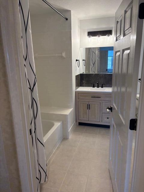 1200 Town Center Drive, Unit 427 Jupiter, FL 33458 - Photo 27 of 33 a bathroom with a tub sink and mirror