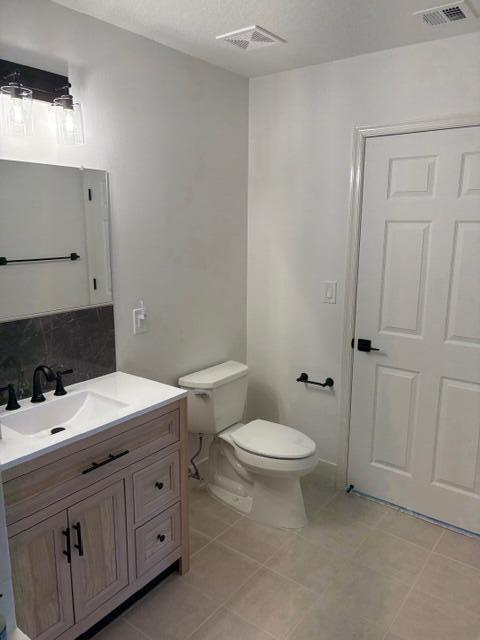 1200 Town Center Drive, Unit 427 Jupiter, FL 33458 - Photo 30 of 33 a bathroom with a double vanity sink toilet and mirror